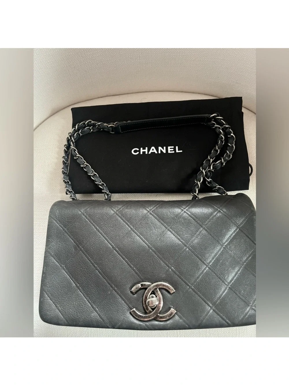 CHANEL Black Quilted Lambskin Shoulder Bag with Silver CC Lock.